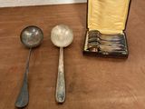 two spoons and two spoons sitting on a table