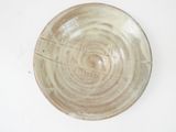 a white plate with a brown design on it