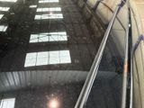 a reflection of a building on the glass of an escalator