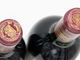 two bottles of wine sitting next to each other on a table