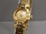 an image of a close up of a wrist watch on a display stand