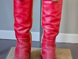 a close up of a pair of red boots with tassels on them