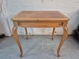 a small wooden table with a drawer on top of it