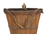 a large wooden basket with a handle on a white background