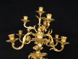 a gold colored candelab with many candles on it