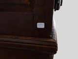 a close up of a wooden bed with a button on it