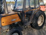 a tractor that is parked on the side of the road