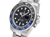a close up of a wrist watch with a blue bezel