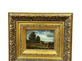 un tableau représentant un paysage avec une rivière et des arbres, dans un cadre doré