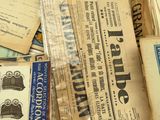 a pile of old newspapers sitting on top of a table