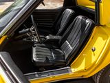 a yellow car with black leather seats and a steering wheel