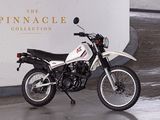 a motorcycle parked in front of the pinnacle collection sign