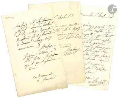 two old letters are sitting on top of a piece of paper