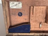 an old wooden box with tools in it on a table