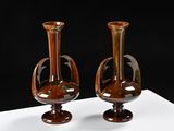 two vases that are sitting on a white table