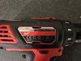 a close up of a cordless drill on a table