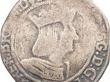 a close up of a coin with a man ' s head on it