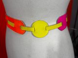 a white mannequin torso with a colorful belt on it
