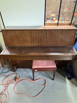a piano that is sitting in the corner of a room