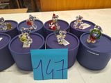 a lot of small figurines sitting on top of a blue container