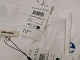 a white t - shirt that has a tag on it