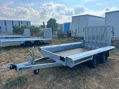 the trailer is parked in a field with other trailers in the background