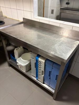 a stainless steel work table in a commercial kitchen