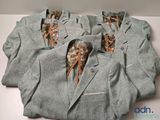 several suits are lined up on a white surface