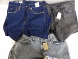 three pairs of jeans are stacked on top of each other