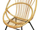 the chair is made of wicker and has a black metal frame