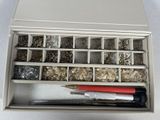 a metal box with many different types of screws in it