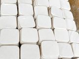 a pile of white containers sitting on top of a table