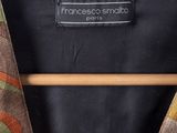 a close up of a jacket on a hanger on a white background