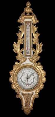 une horloge dorée et blanche sur fond noir