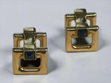 pair of gold tone cufflinks with blue stones on them