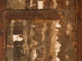 a picture of an old wooden door with peeling paint on it