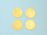 four gold coins are arranged in a row on a blue surface
