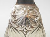 a silver vase sitting on a table with a white background
