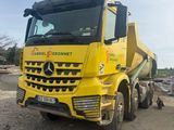 un gros camion jaune garé sur le bord de la route