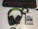 a keyboard, headphones, and a mouse on a table