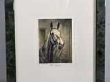 painting of a white horse in a green frame on a table