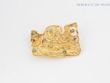 an image of a gold brooch with turquoise stones on it