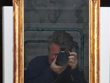 a man taking a picture of himself in a mirror