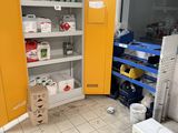 a yellow cabinet in the middle of a room with a microwave in it