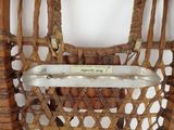 a close up view of a wicker chair with a label on it