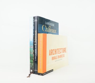 two books are stacked on top of each other on a white surface
