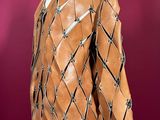 an image of a mannequin wearing a brown jacket with barbed wire on it