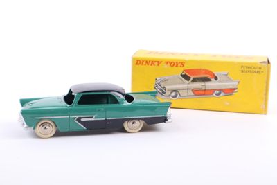 an old toy car with a box of toys in the background