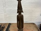 statue of a man with a hat on his head sitting on a table