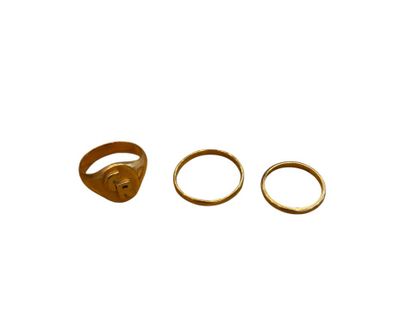 two gold rings and a ring on a white background